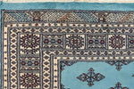 Close-up view of the Javarak Blue Hand Knotted Area Rug, showcasing intricate patterns and vibrant colors ideal for large living room spaces. This detailed design makes it a standout choice among area rugs for living rooms.
