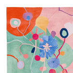 Vibrant abstract design on a contemporary wool area rug, featuring colorful floral and geometric patterns. Ideal for large living rooms, this hand-tufted rug adds a joyful touch to any space.