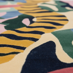 Close-up of a colorful patterned rug with abstract shapes and vibrant colors.