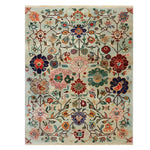 The Kaleidoscope Garden Knotted Wool Rug is a vibrant area rug featuring an intricate floral pattern with colorful blooms and vines. Ideal for large living room spaces, this floral rug adds a touch of elegance and warmth to any home decor.