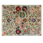 The Kaleidoscope Garden Knotted Wool Rug showcases an intricate floral pattern, ideal for adding a touch of elegance to any large living room. This area rug features vibrant colors and detailed flower motifs, perfect for those seeking a statement floral rug.