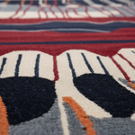 Close-up of a colorful patterned rug with geometric shapes.