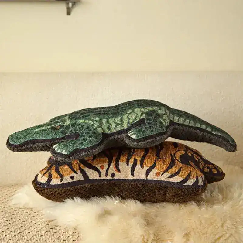 Decorative throw pillows featuring a crocodile design on top of a tiger pattern, perfect for adding a wild touch to your home decor.