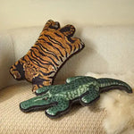 Decorative throw pillows featuring a tiger and an alligator design, perfect for adding a wild touch to your home decor.