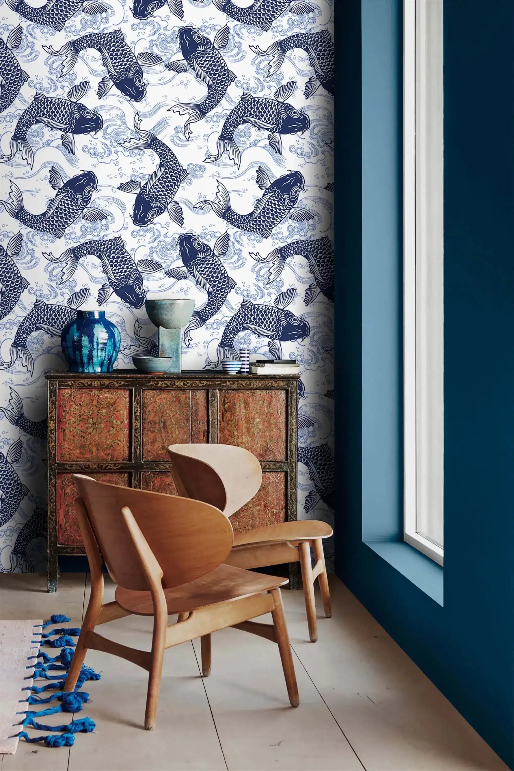 Koi Pond Serenity blue koi wallpaper next to a navy wall above an antique cabinet and wood chair