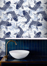 Koi Pond Serenity indigo koi wallpaper above navy tiles with a marble vessel basin and brass tap