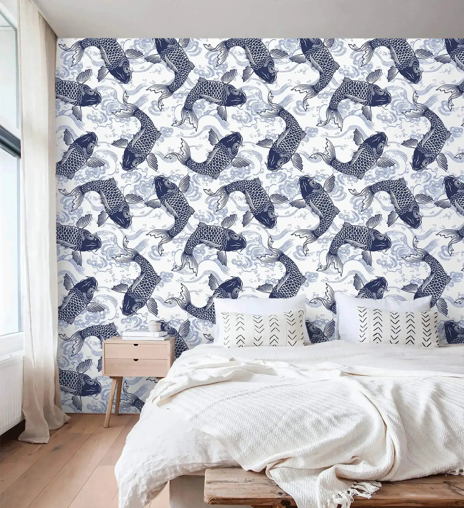 Koi Pond Serenity wallpaper, indigo koi on white, behind a bed with cream linens and nightstand