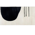 This contemporary runner rug features a striking abstract design with bold black and white shapes, making it a perfect choice for modern kitchens, hallways, or bathrooms. The hand-tufted wool construction ensures durability and softness, ideal for use as a kitchen rug or hallway runner rug.