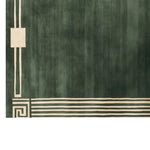 A contemporary wool area rug featuring a sophisticated geometric pattern in a rich green hue. The rug displays intricate lines and a unique design, ideal for enhancing the elegance of living room area rugs. Perfect for those seeking high-quality area rugs for living rooms.