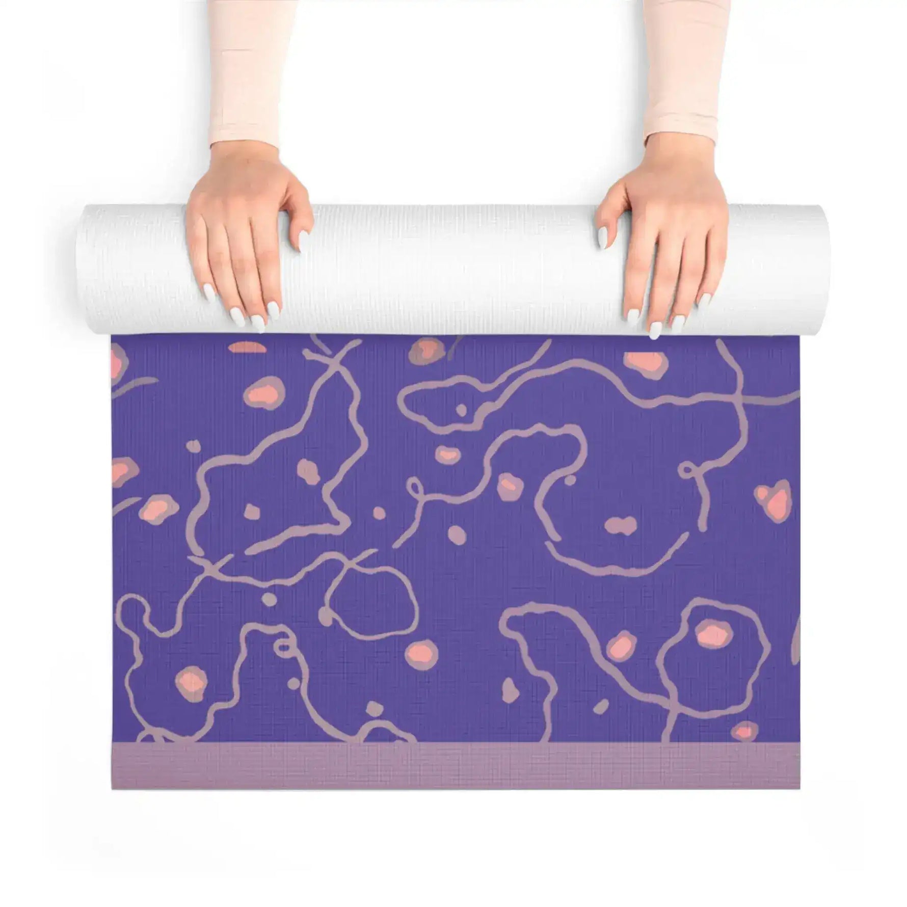 Hands unrolling the Lavender Dreams Yoga Mat, purple mat with pink dots and grey swirls