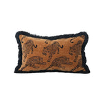 Throw pillow featuring a lavish leopard design on a brown background with fringed edges, perfect for adding a bold touch to your home decor.