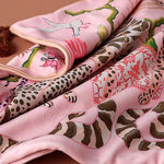 Lavish twin leopard oasis throw pillow cover featuring vibrant pink fabric adorned with playful leopard and floral patterns, perfect for adding a pop of color to your home decor.