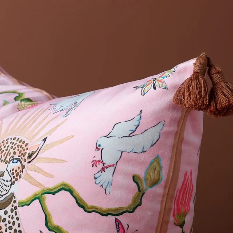 Lavish Twin Leopard Oasis throw pillow cover featuring vibrant illustrations of leopards, birds, and flowers, accented with decorative tassels.