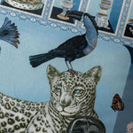 Decorative throw pillow featuring a lavish twin leopard design with tassels, incorporating vibrant colors and intricate details.