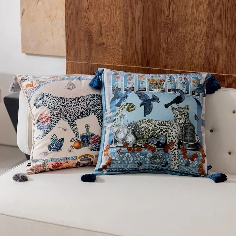 Decorative throw pillows featuring twin leopard designs with colorful tassels, perfect for adding a touch of luxury to your home decor.