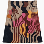 Colorful abstract patterned rug on a dark background