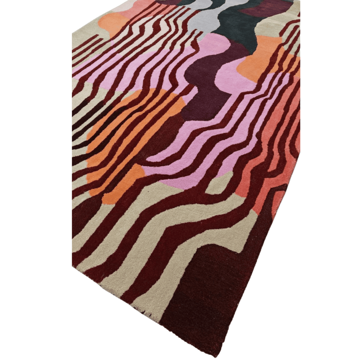 Colorful abstract patterned rug on a green background