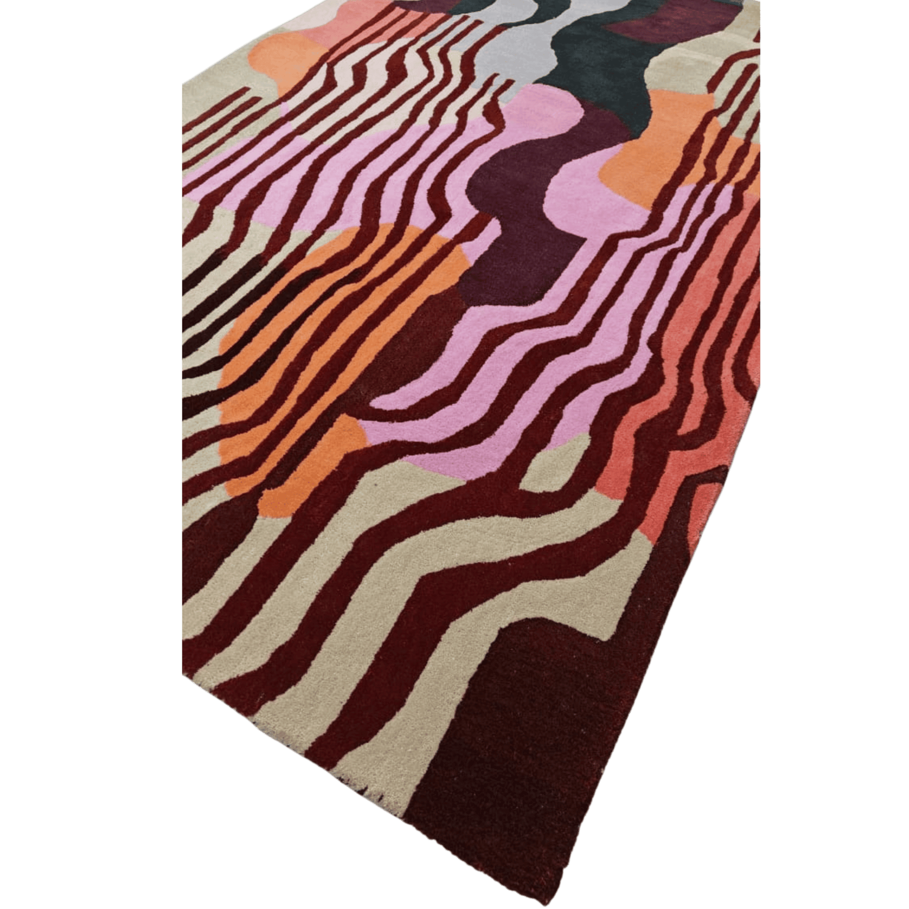 Colorful abstract patterned rug on a green background