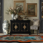 A contemporary area rug in a living room setting, featuring an abstract design with vibrant colors. The rug complements the elegant decor, including a black cabinet, zebra-patterned chair, and framed zebra artwork. Perfect as a wool rug for living room spaces, especially in 8x10 size.
