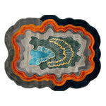 Stylish and modern area rug featuring a vibrant abstract design with layered colors of blue, orange, and gray, perfect for contemporary living rooms. This hand-tufted wool rug adds a unique touch to any space, ideal for an 8x10 living room setting.