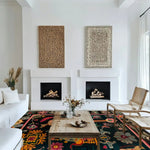 A stunning living room showcases the Legacy Majestic Tapestry Wool Hand Knotted Area Rug, featuring vibrant floral patterns on a dark background. This square area rug perfectly complements the white sofas and wooden coffee table, adding a touch of Persian elegance to the space. Ideal for anyone seeking a luxurious wool rug for their living room.
