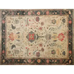 This vintage area rug, titled 'Legacy of Petals Hand Knotted Area Rug', features an intricate floral design reminiscent of Persian rugs. The rug showcases a harmonious blend of colors including red, beige, and blue, making it a perfect addition to living room decor.