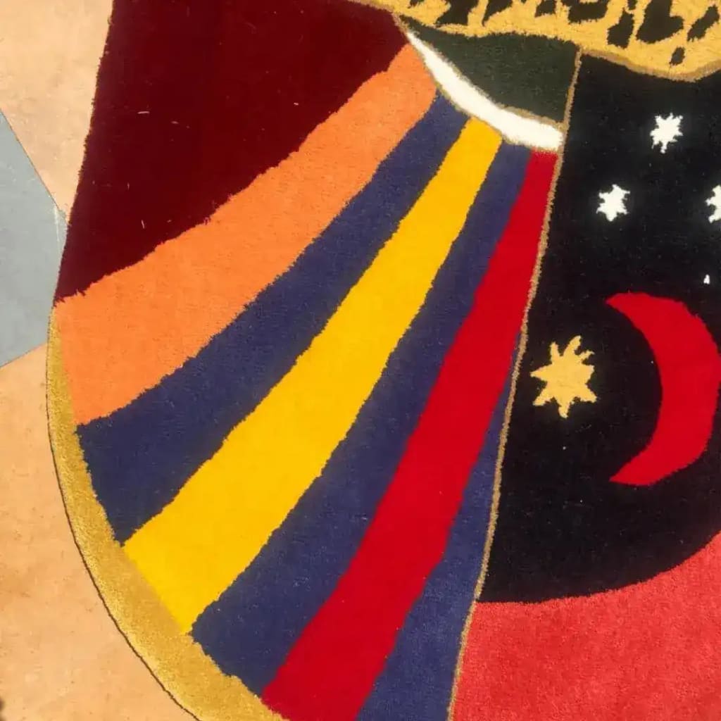 Close-up view of the Leopard Crossing the Sun Hand-Tufted Area Rug in red, showcasing its vibrant abstract design with bold colors and celestial motifs, perfect for adding a pop of color to formal dining room rugs, dining room carpets, or any wool rug setup in a dining room.