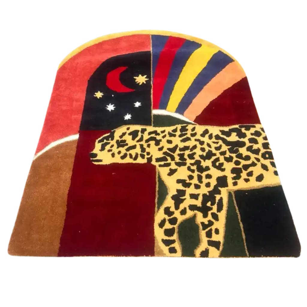 The Leopard Crossing the Sun Hand-Tufted Area Rug in vibrant red showcases a striking design with a leopard and abstract celestial elements. Perfect for adding a bold statement to formal dining room rugs or as a unique wool rug in your dining room setting.