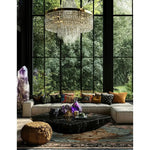 A luxurious living room featuring a Leopard Legacy Wool Hand Knotted Area Rug under a stylish black marble coffee table. The square area rug adds warmth and elegance to the space, perfect for both living room and bedroom settings. Surrounded by a plush sectional sofa adorned with colorful cushions, and set against a backdrop of large windows showcasing a lush green outdoor view, the wool rug enhances the cozy ambiance.