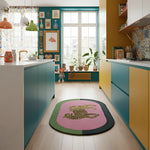 Colorful kitchen with teal and yellow cabinets, a pink tiger wool rug with a leopard design, and decorative elements.