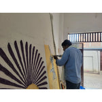 A skilled artisan meticulously crafting the 'Leopards on Silk Road Tufted Wool Rug Runner'. This area rug, perfect for spaces like the dining room, kitchen, or as a hallway runner rug, showcases intricate leopard designs on quality wool. Ideal for those seeking kitchen runner rugs or bathroom runner rugs to elevate their home decor.