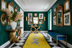 Decorative interior with green walls, gold mirrors, and a yellow rug.