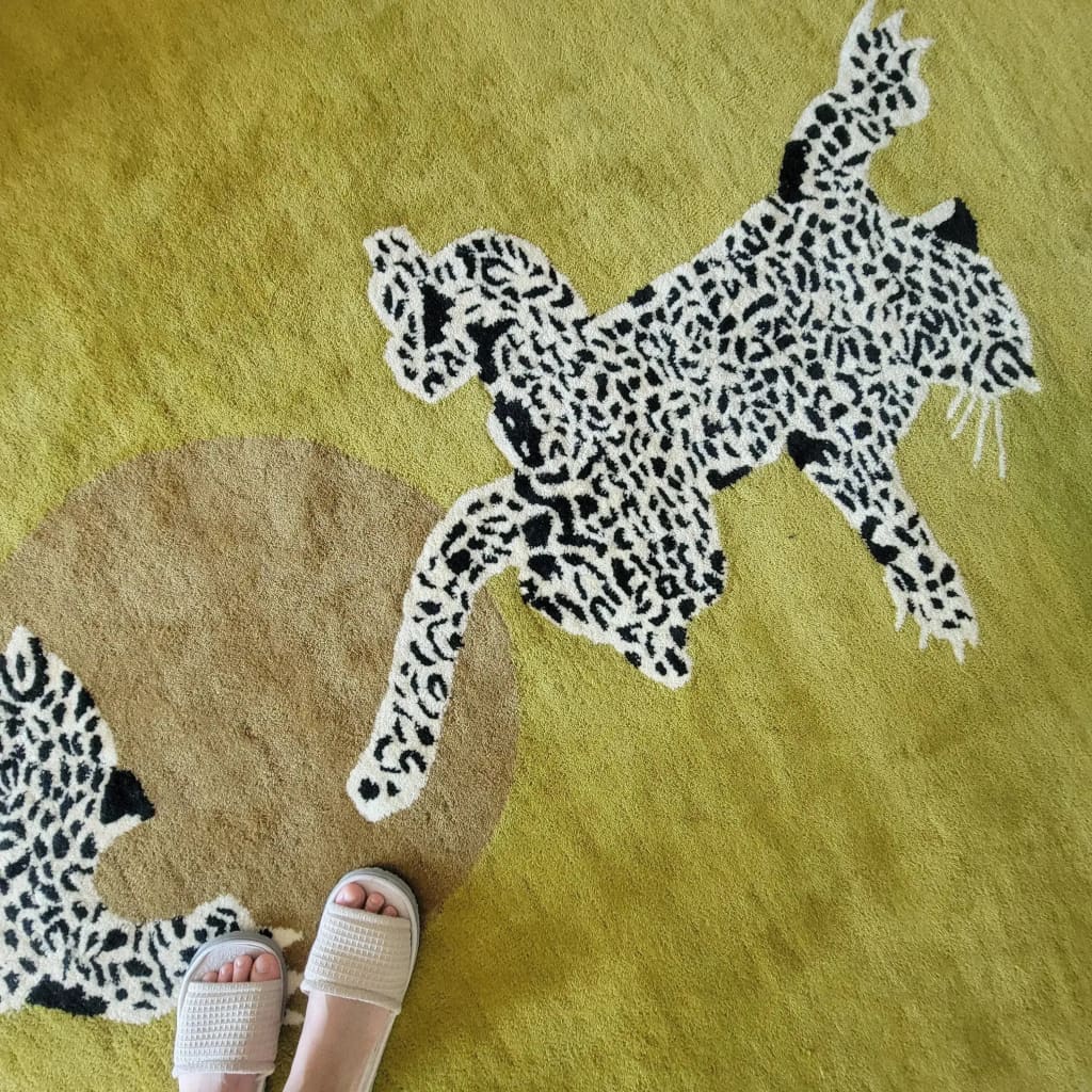 Close-up of the 'Leopards on Silky Road' hand tufted wool rug runner, featuring a striking leopard design on a soft, earthy background. Ideal as a large area rug for living rooms, kitchen runner rugs, or hallway runner rug. This unique wool rug adds a touch of wildlife elegance to any space, making it perfect for living room rugs 8x10, kitchen rugs, and even as a bathroom runner rug.