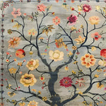 A beautifully detailed hand-knotted area rug featuring a vintage floral design. The rug displays an intricate pattern of colorful flowers and branches against a muted background, making it an ideal Persian-style rug for living rooms. This floral rug combines elegance and timeless charm, perfect for enhancing any interior space with its vibrant and classic aesthetic.