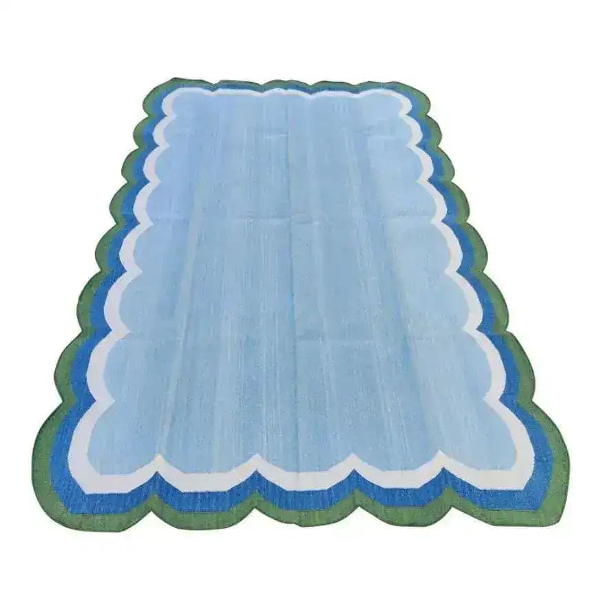 Light blue handmade reversible cotton scalloped area rug, perfect for living room decor. This boho rug adds a touch of elegance to your space, ideal for those seeking unique living room area rugs.