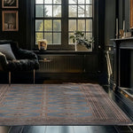 A beautifully designed Light Slate Grey Rajastani Hand Knotted Area Rug graces a sophisticated living room. This 8x10 area rug features intricate patterns, complementing the stylish and cozy ambiance of the space. Ideal for adding elegance to any living room setting.