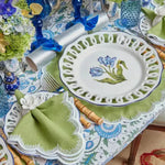 Lily of the Valley Elegance placemat under white lattice-rim china with blue tulip, green napkin, white flower ring