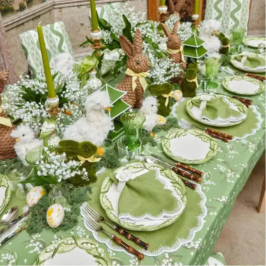 Lily of the Valley Elegance placemats in full spring table, green scalloped mats, lily-print china, Easter bunny centerpiece