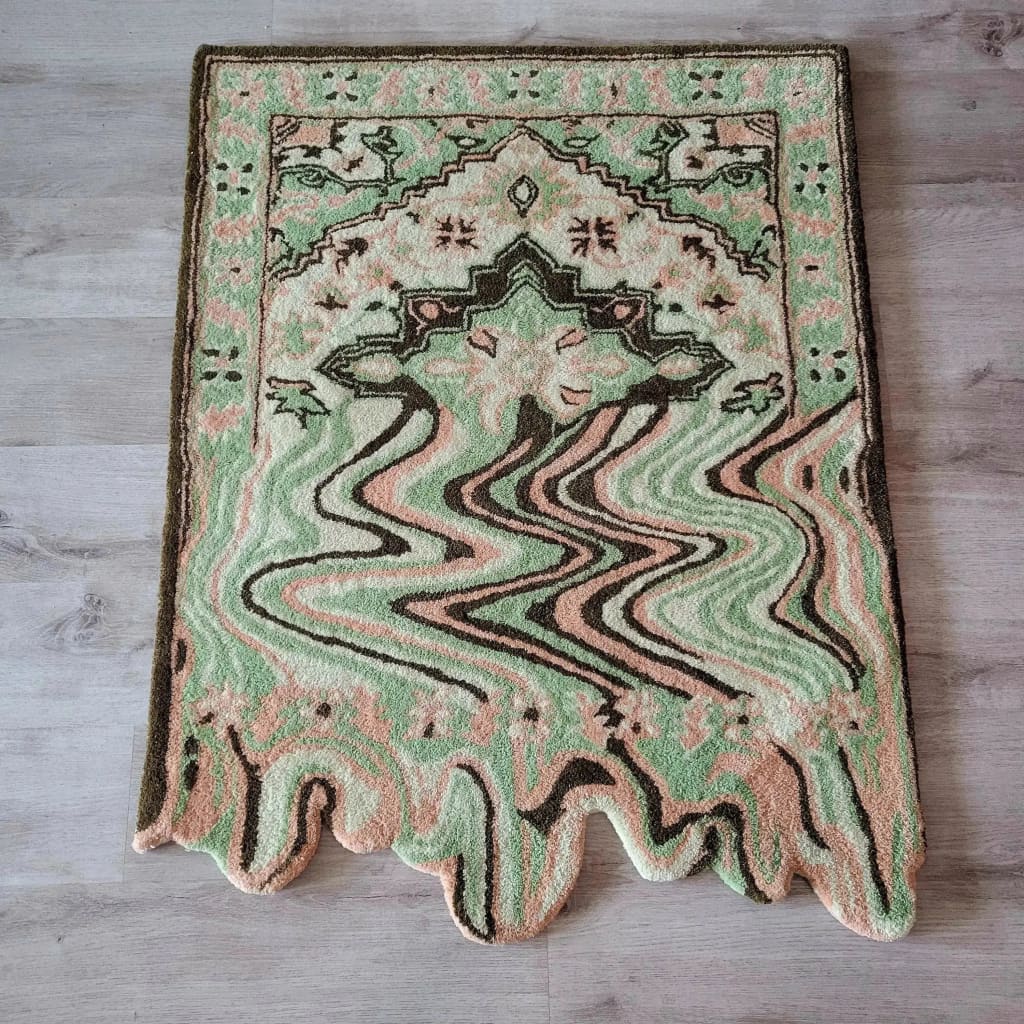 A vibrant Lime Green Melting Traditional Persian Hand Tufted Wool Rug displayed on a wooden floor. This abstract area rug features a blend of green, peach, and brown tones, ideal for enhancing dining rooms or living room spaces with its unique design.