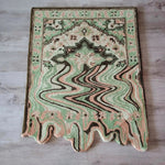 A vibrant Lime Green Melting Traditional Persian Hand Tufted Wool Rug displayed on a wooden floor. This abstract area rug features a blend of green, peach, and brown tones, ideal for enhancing dining rooms or living room spaces with its unique design.