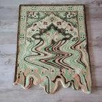 A vibrant Lime Green Melting Traditional Persian Hand Tufted Wool Rug displayed on a wooden floor. This abstract area rug features a blend of green, peach, and brown tones, ideal for enhancing dining rooms or living room spaces with its unique design.