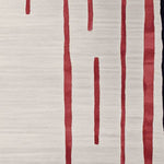 Close-up of a contemporary wool area rug featuring bold red linear patterns on a soft beige background, perfect for adding modern elegance to living room spaces.