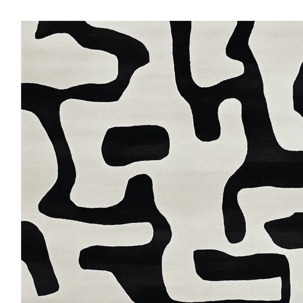 A contemporary area rug with an abstract black and white pattern, perfect for modern living rooms. This wool rug adds a touch of elegance and sophistication, making it an ideal choice for area rugs in living room settings.