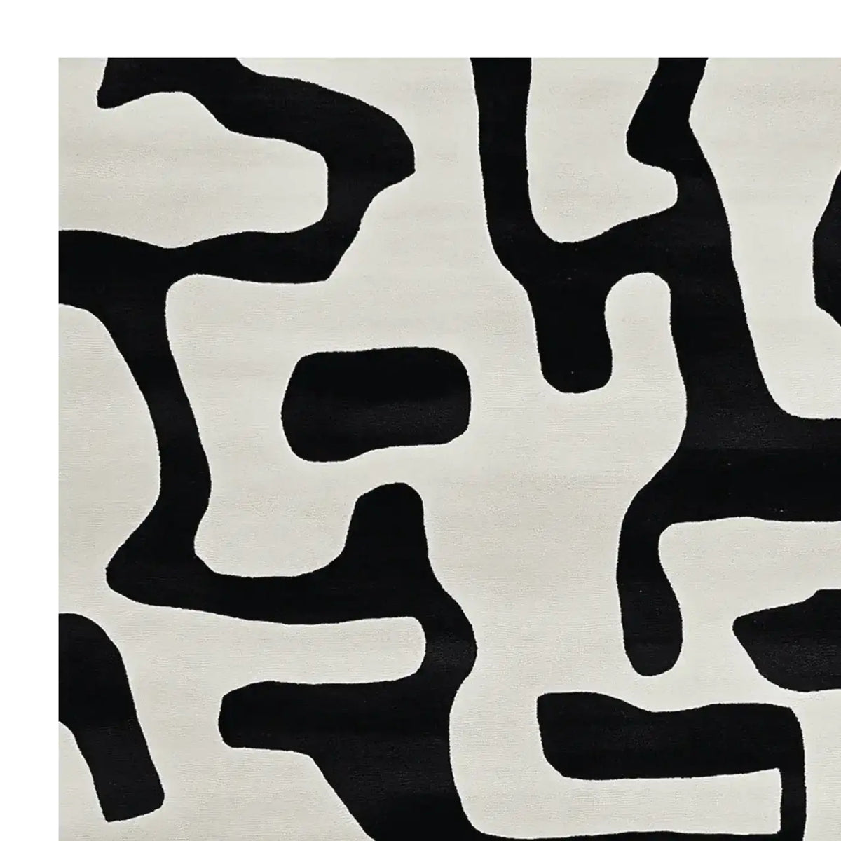 A contemporary area rug with an abstract black and white pattern, perfect for modern living rooms. This wool rug adds a touch of elegance and sophistication, making it an ideal choice for area rugs in living room settings.