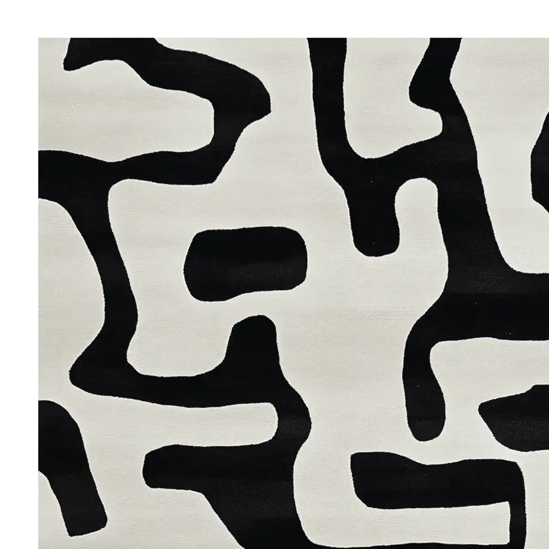 A contemporary area rug with an abstract black and white pattern, perfect for modern living rooms. This wool rug adds a touch of elegance and sophistication, making it an ideal choice for area rugs in living room settings.