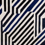 A stylish area rug featuring a bold, contemporary design with striking black and white geometric stripes. This wool rug is perfect for adding a modern touch to large living rooms, making it a standout area rug for any living room setting.