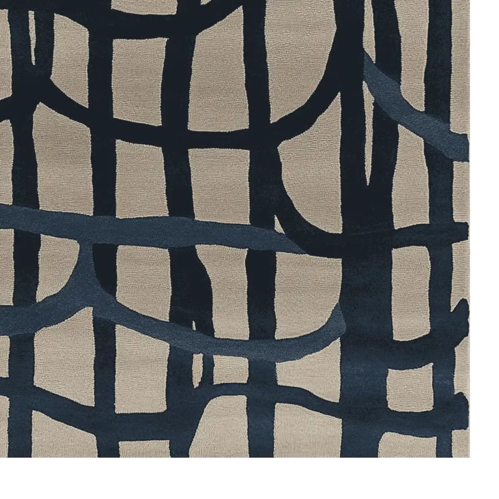 A close-up view of a contemporary hand-tufted wool area rug, featuring an abstract design with bold, dark blue intersecting lines on a light beige background. This large living room rug adds a modern touch to any space, making it an ideal choice for those seeking stylish living room area rugs.