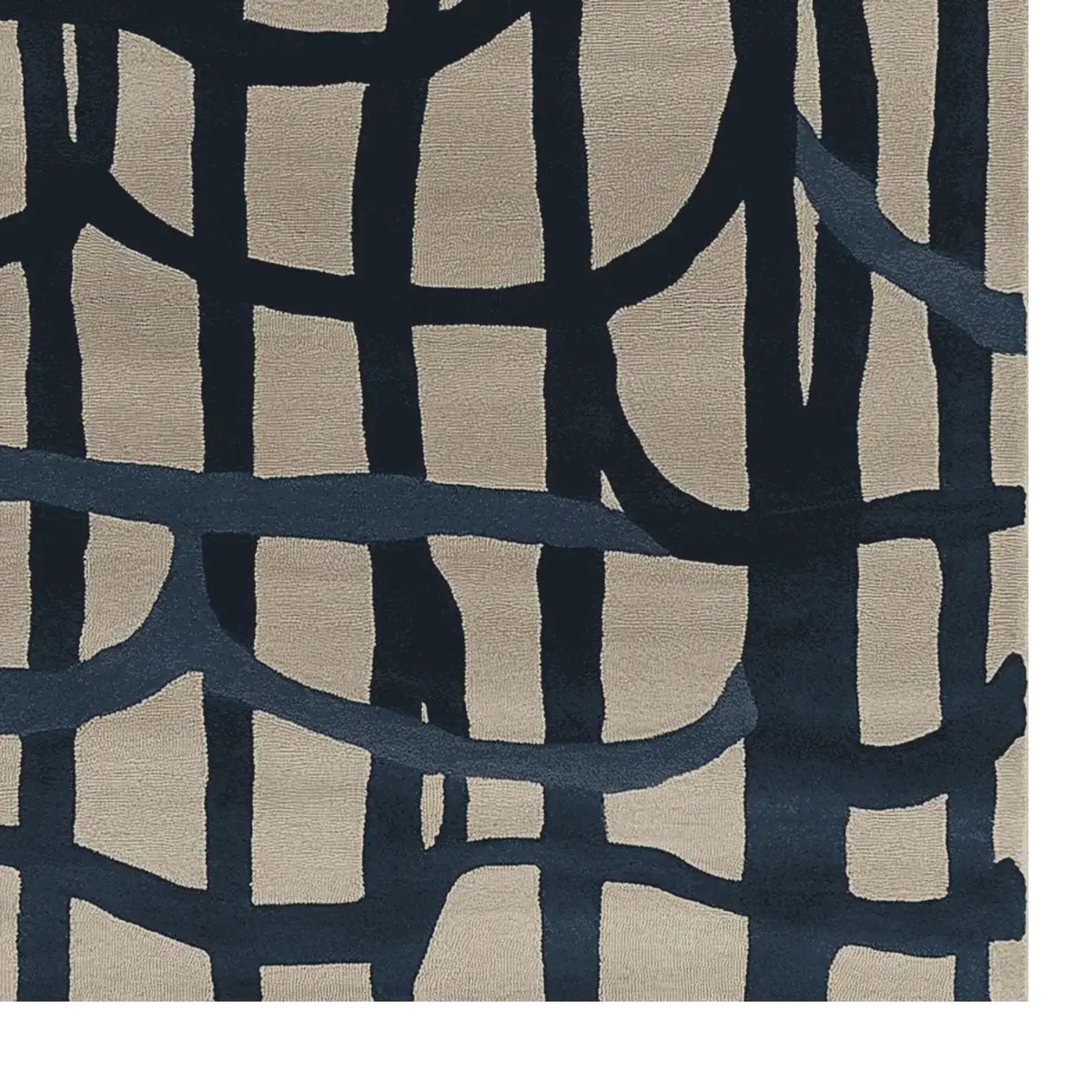 A close-up view of a contemporary hand-tufted wool area rug, featuring an abstract design with bold, dark blue intersecting lines on a light beige background. This large living room rug adds a modern touch to any space, making it an ideal choice for those seeking stylish living room area rugs.