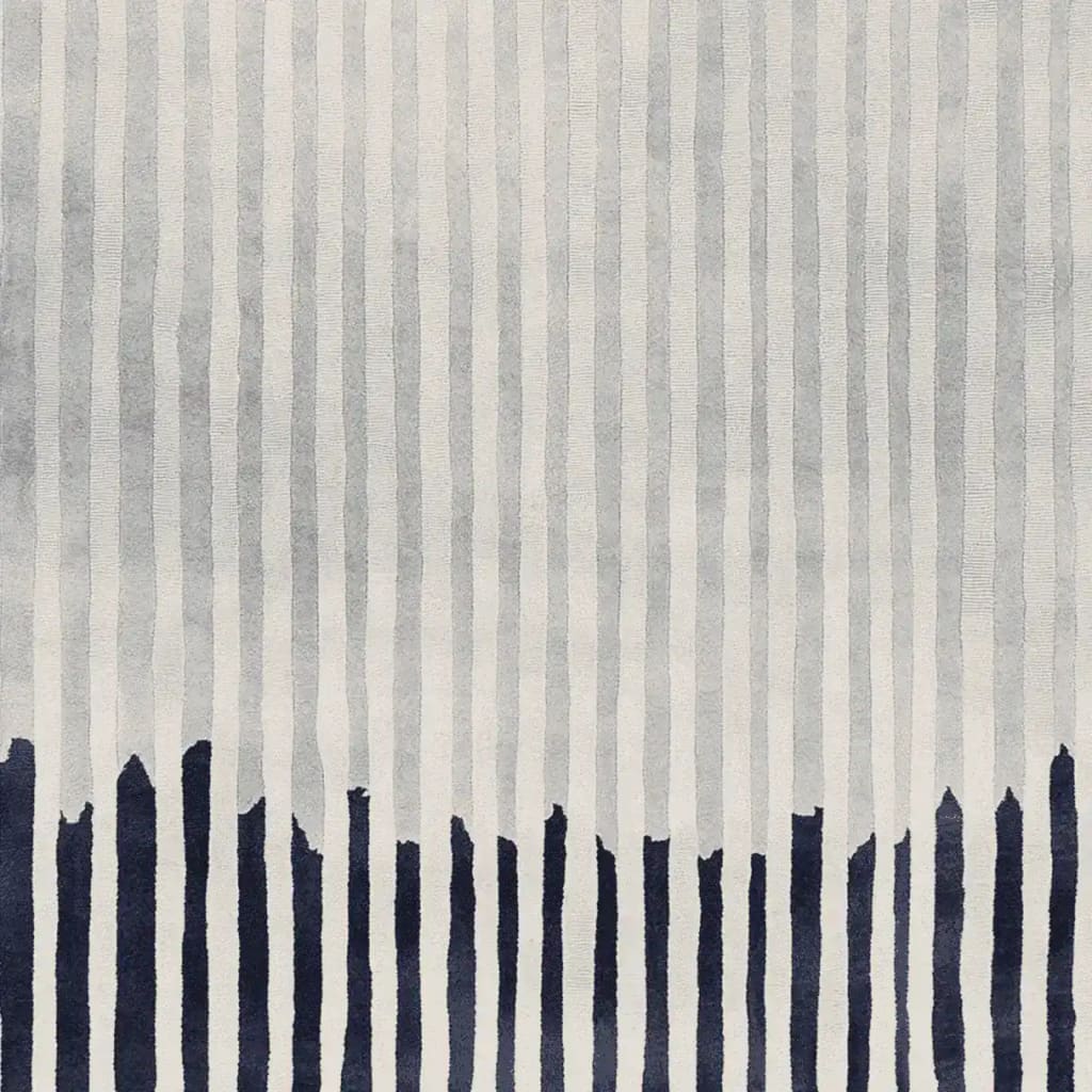 This contemporary rug features a dynamic pattern of vertical lines in shades of gray with bold navy accents at the bottom. Perfect for enhancing the style of any living room, this hand-tufted wool rug adds a touch of modern elegance, making it an ideal choice for those seeking unique area rugs for living room decor.