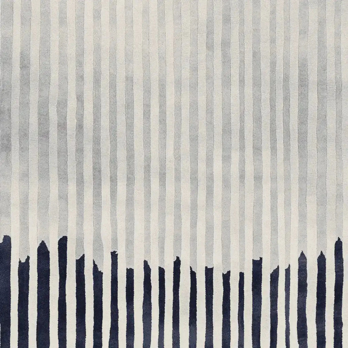 This contemporary rug features a dynamic pattern of vertical lines in shades of gray with bold navy accents at the bottom. Perfect for enhancing the style of any living room, this hand-tufted wool rug adds a touch of modern elegance, making it an ideal choice for those seeking unique area rugs for living room decor.